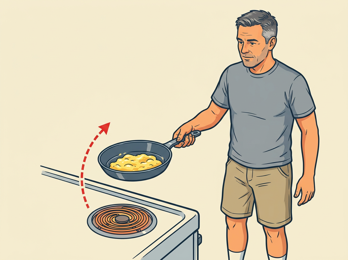 6: LIFT the whole pan off the burner while the eggs still look glossy and a little underdone.