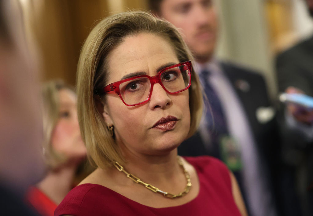 Men Shout Affair Claims at Kyrsten Sinema Panel as Ex-Bodyguard’s Wife Alleges Romance