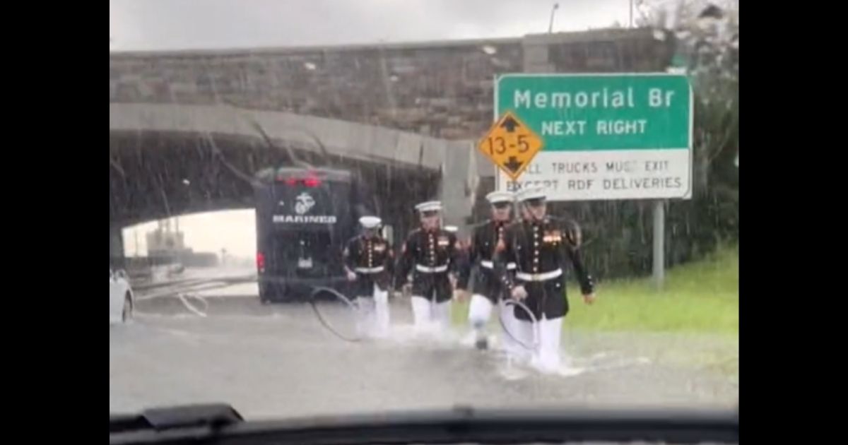 Woman Stuck in Flood Can’t Believe Her Eyes as Cadre of Marines in Dress Blues Begins Wading To Her