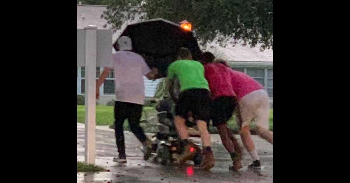 Four Men Push Elderly Woman in Scooter Nearly a Mile After It Breaks Down in the Rain