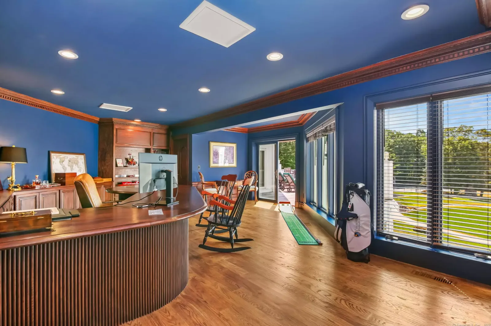 An office with its own bar and putting green.