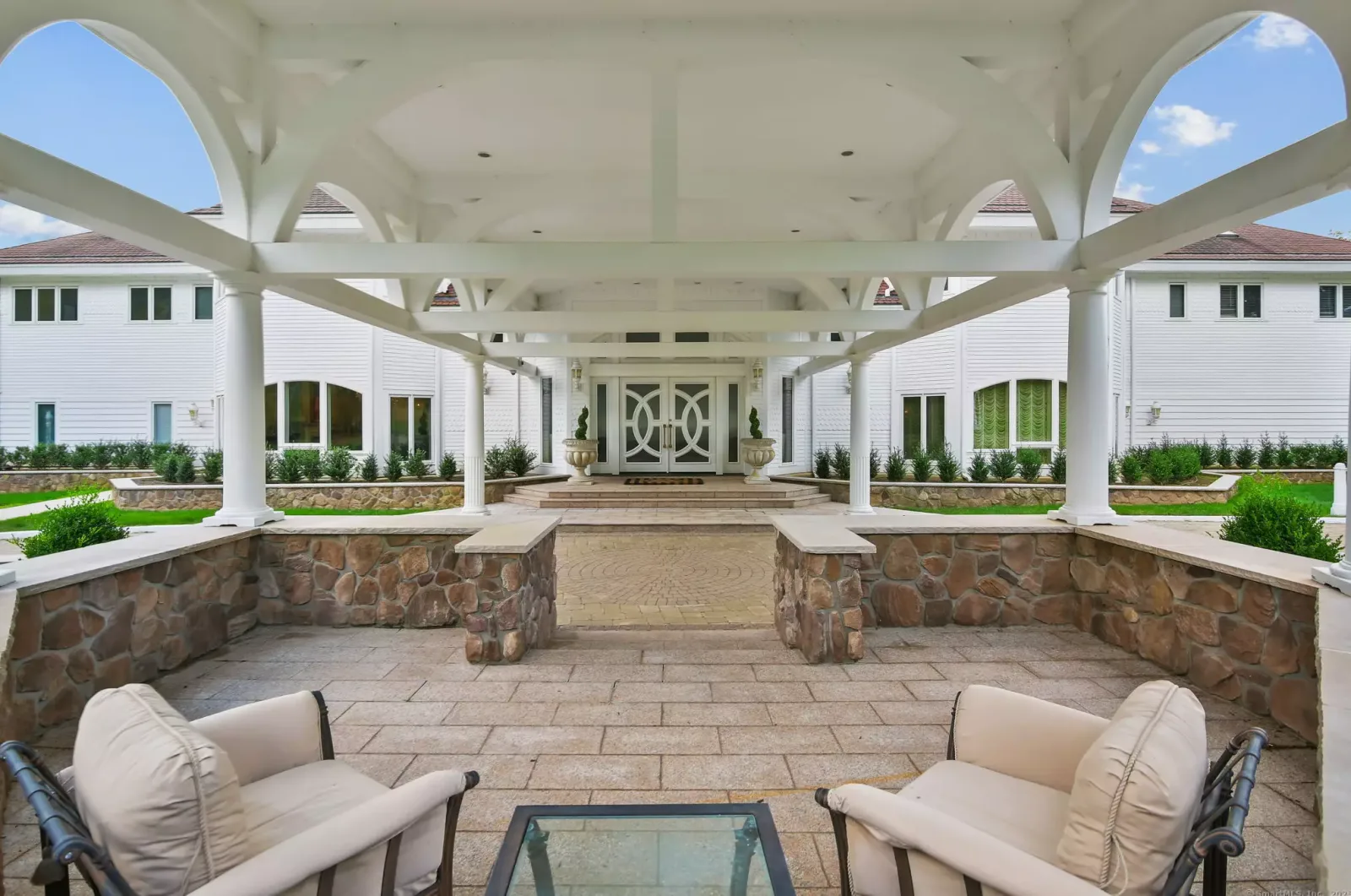 The covered patio and fountain behind the house.