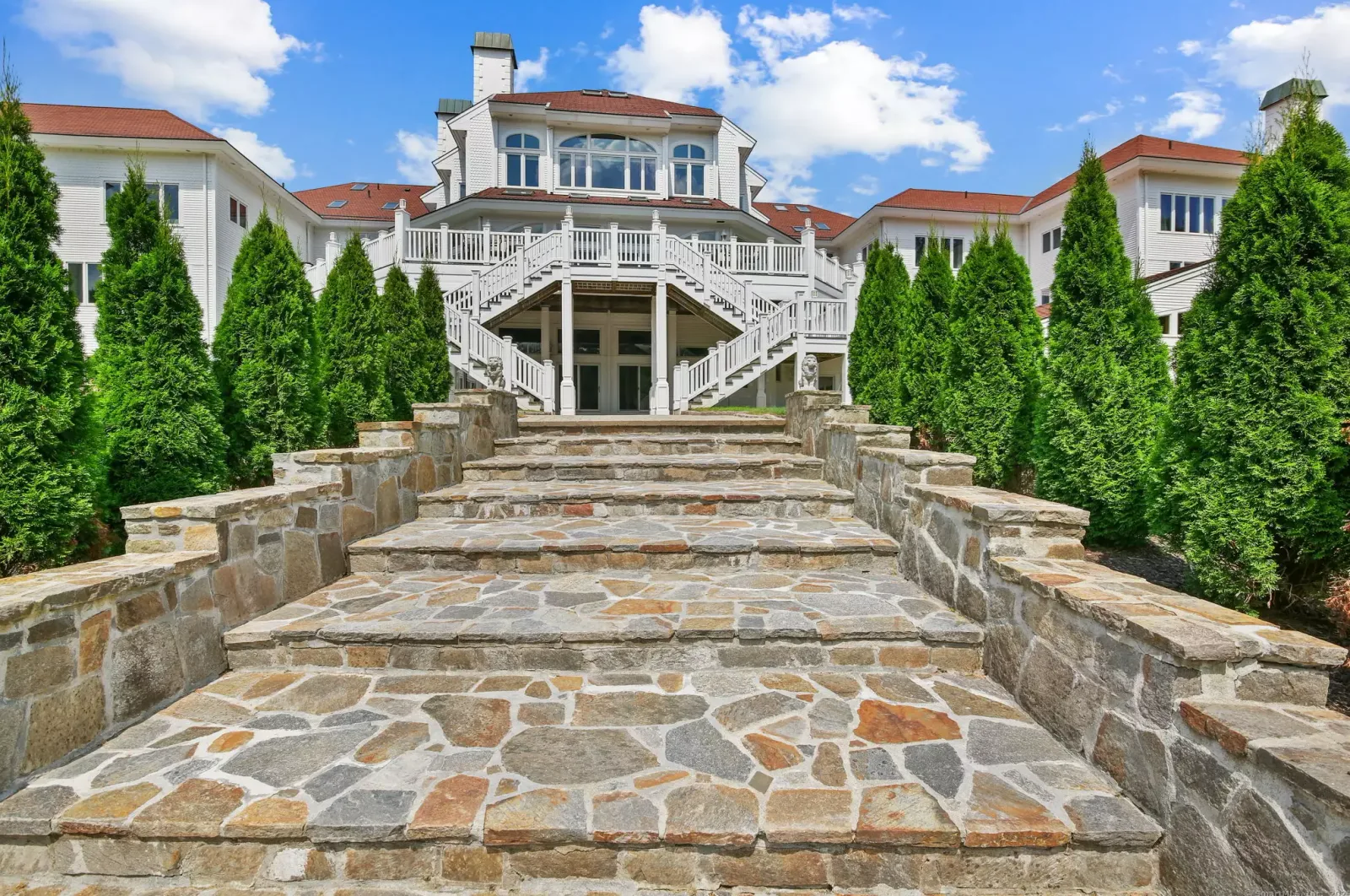 The terrace steps up to the rear of the main house.