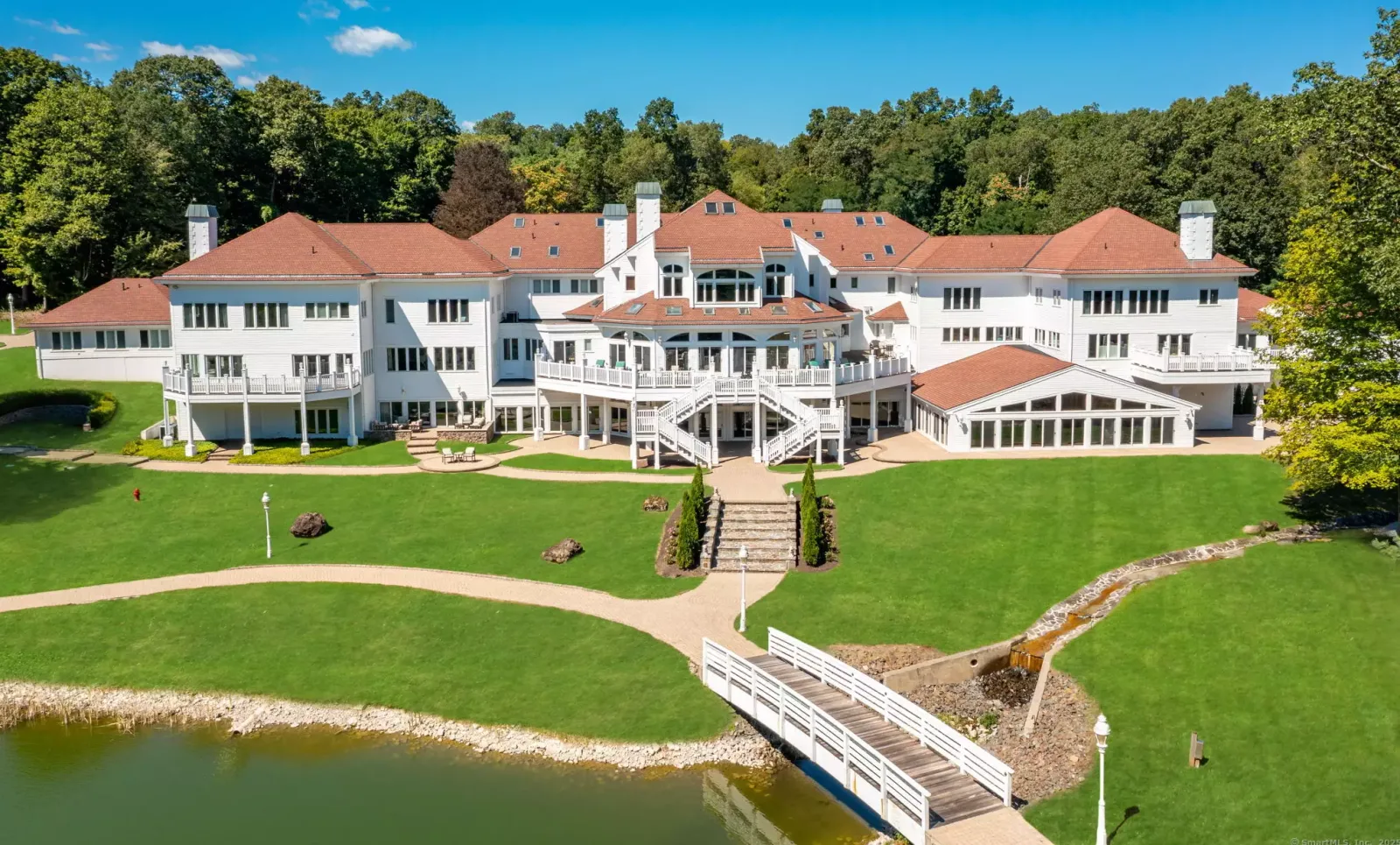 The back of the house from over the pond and its footbridge.