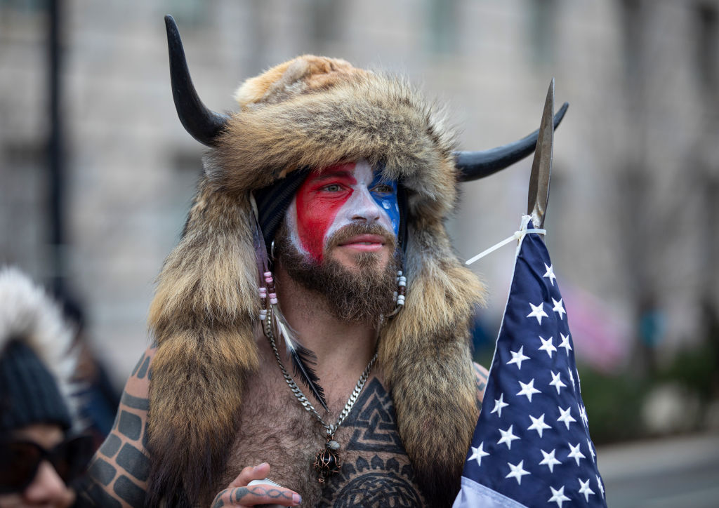 ‘QAnon Shaman’ Seen for First Time Since Release from Federal Prison – Look at the Shirt He Is Wearing