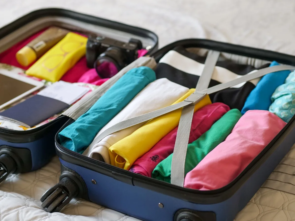 Pack more in a suitcase by rolling clothes and weighting wheels